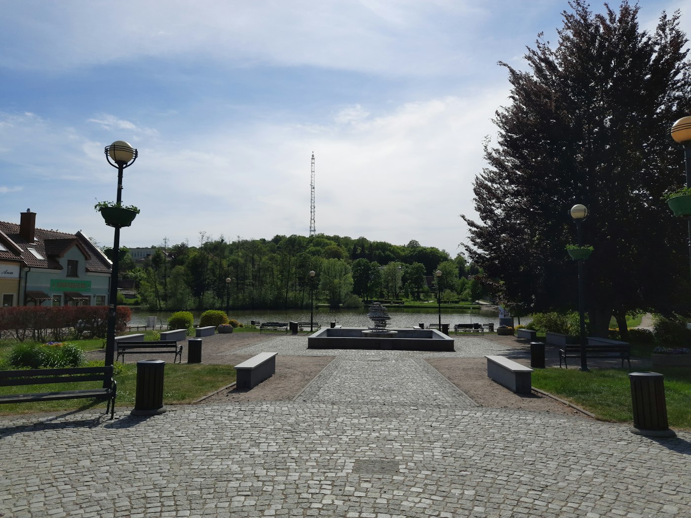 A green city park with a lawn and walking path, illustrative of Ashburn, Virginia parks